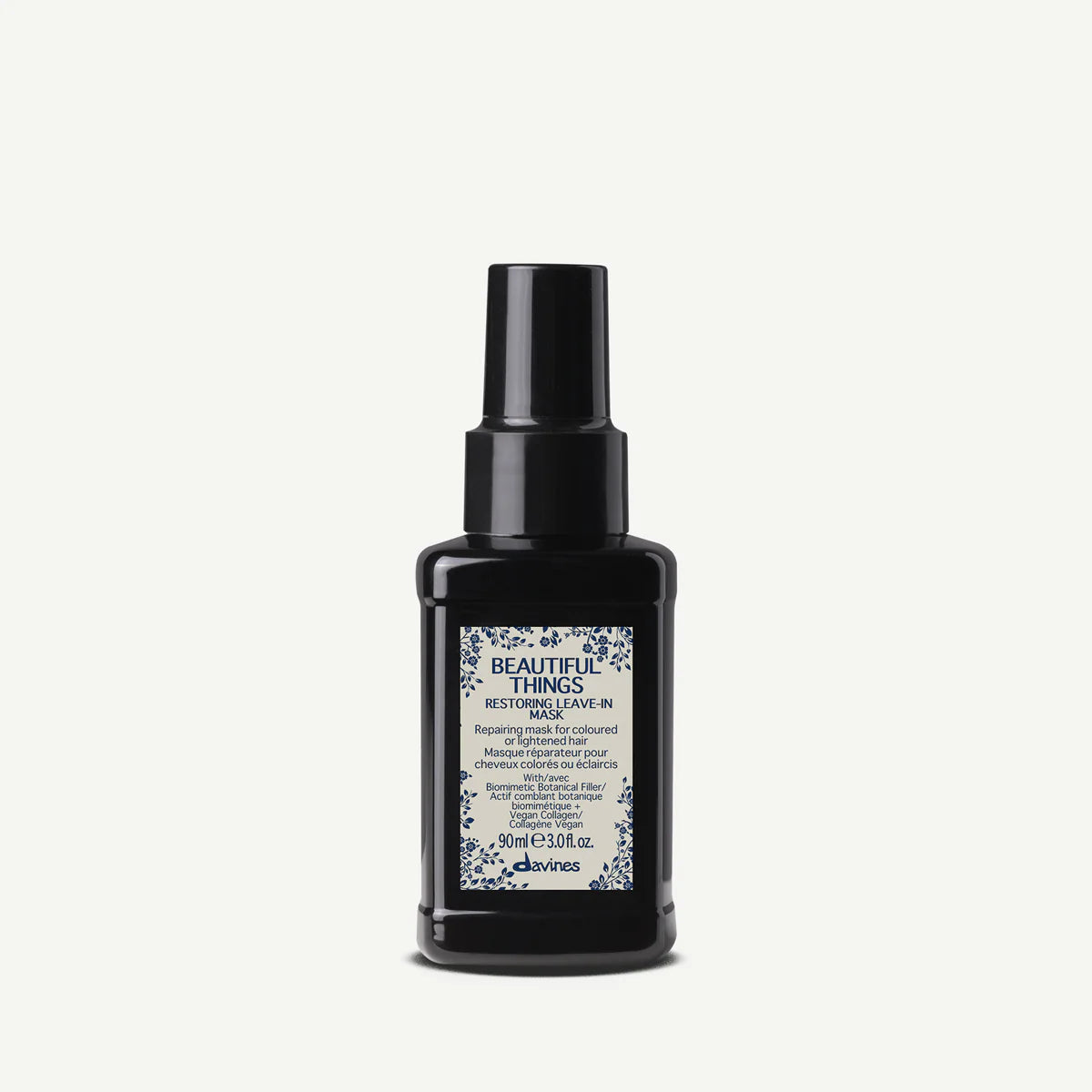 Black bottle of Davines hair product on a white background