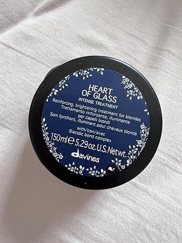 Davines 'Heart of Glass' hair treatment container on a white towel
