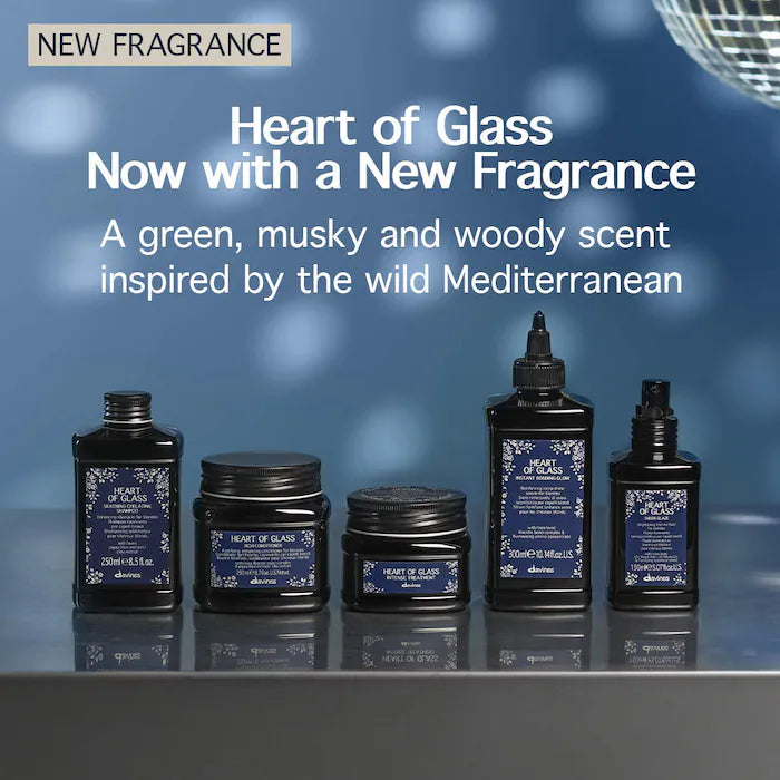 Collection of 'Heart of Glass' fragrance products with a blue gradient background and text about the new fragrance.