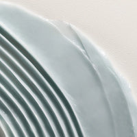 Thumbnail for Close-up of a light blue minu mask with a textured surface on a white background