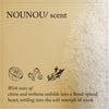 Thumbnail for Product packaging with 'NOUNOU/ scent' and illustrations of citrus, verbena, and musk on a textured beige background.