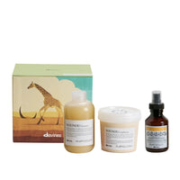 Thumbnail for Davines hair care products including shampoo, conditioner, and serum with a box featuring a giraffe design on a white background.