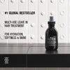 Thumbnail for Black hair treatment bottle on a black surface with white background and text about product features.