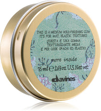 Thumbnail for A round gold metal tin of Davines finishing gum, showing the inner label with product details and the Davines logo.