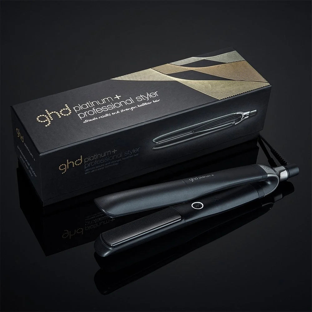 ghd platinum+ hair straightener with packaging on a black background