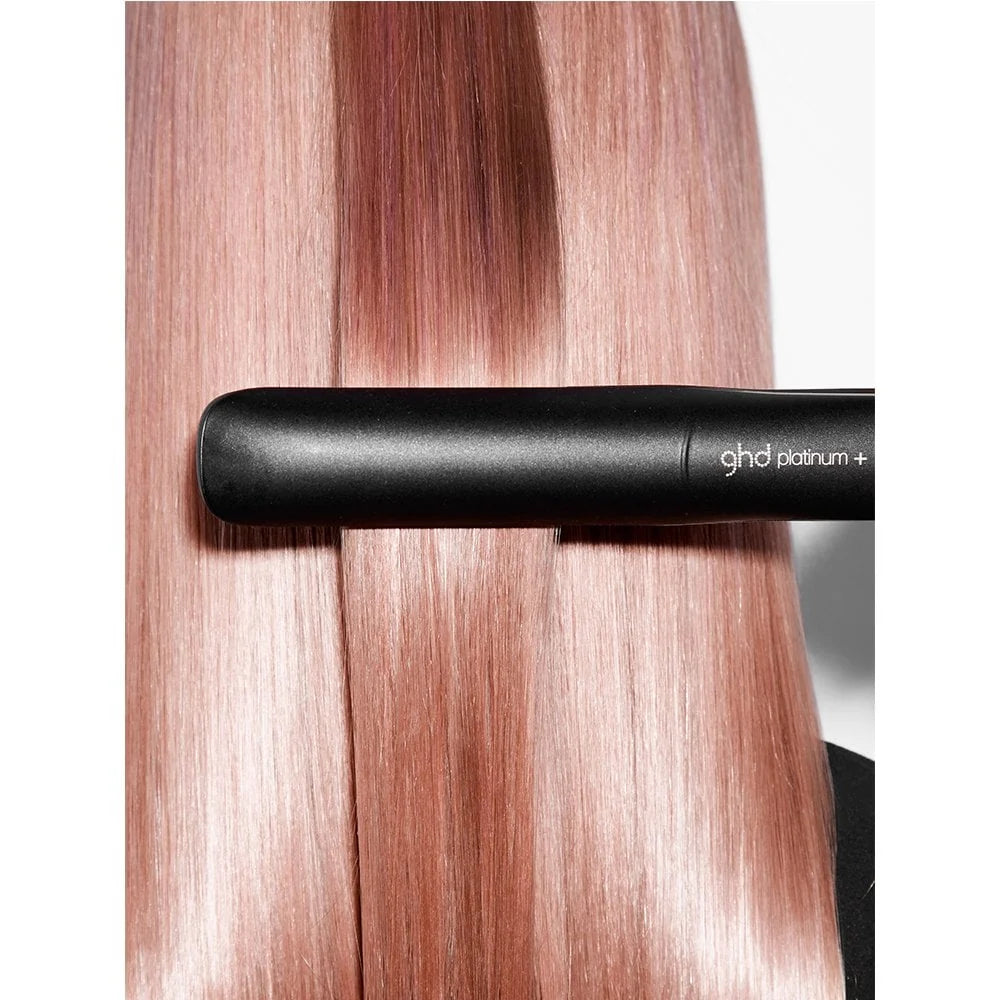 ghd straightener on pink hair with a white background