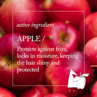 Thumbnail for A close-up background of red apples with a white outlined text box in the center reading 'active ingredient APPLE / Protects against frizz, locks in moisture, keeping the hair shiny and protected,' plus a small white illustrated apple with a red arrow in the lower right.