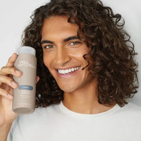 Thumbnail for Man holding Paul Michell Awaphui Shampoo