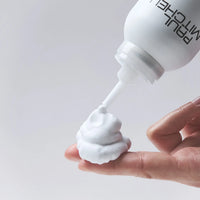 Thumbnail for White cream being squeezed from a bottle onto a hand against a light gray background