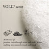Thumbnail for Text description of a VOLU/ scent with notes of jasmine, mint, violet leaves, wood, and musk on a textured beige background.
