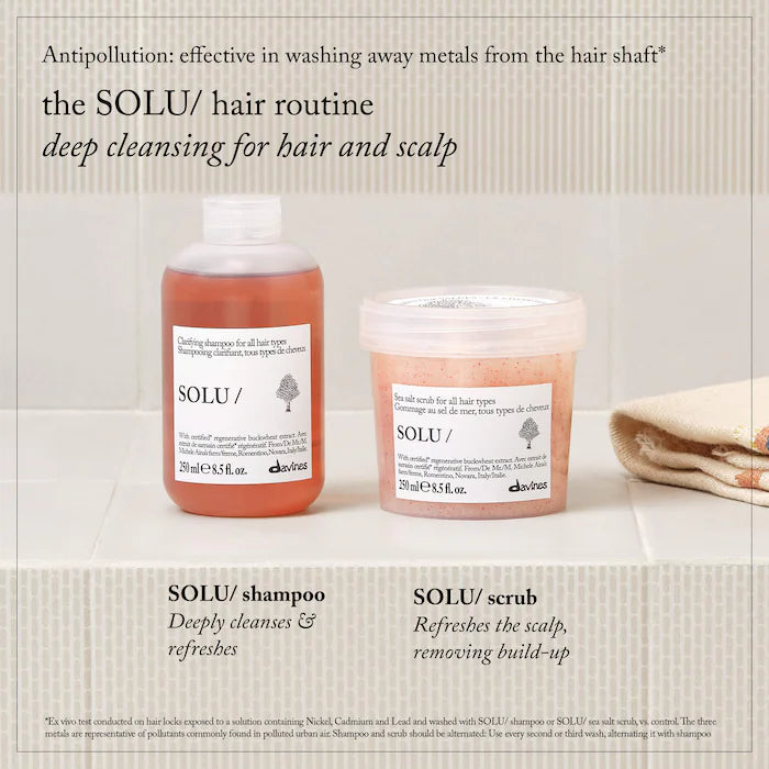 SOLU hair routine set featuring a bottle of SOLU shampoo and a tub of SOLU scrub on a light beige textured background with descriptive text.