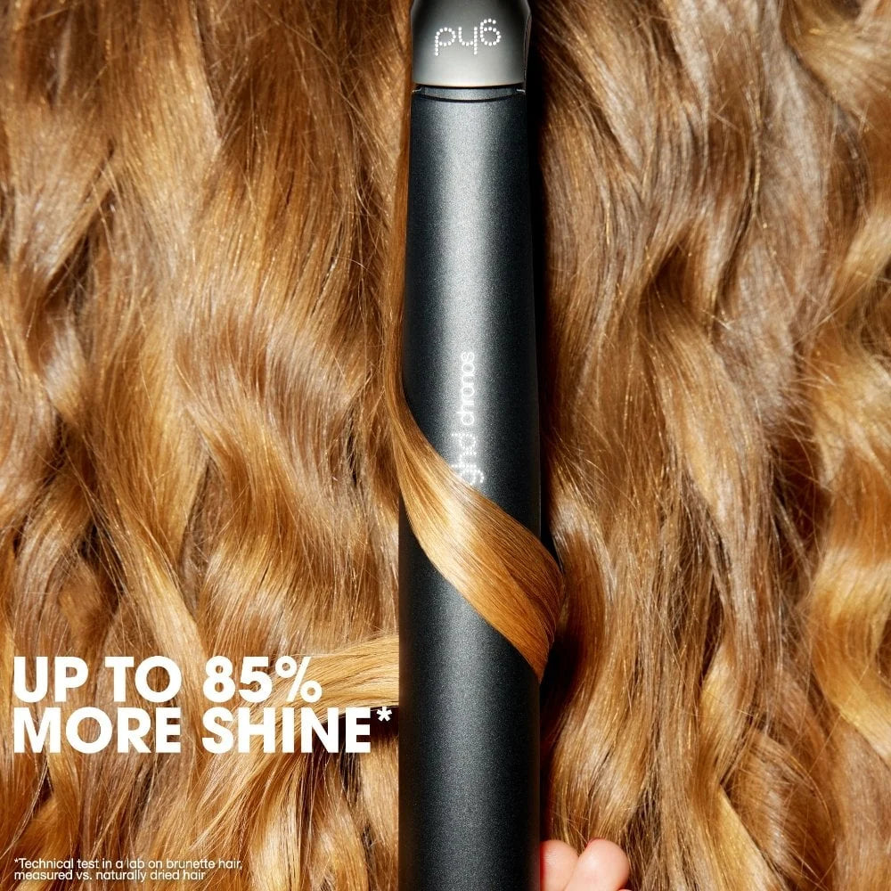 Black hair straightener with wavy hair and text 'Up to 85% more shine' on a close-up of hair.