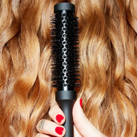 Thumbnail for Black hairbrush being used on wavy blonde hair with a hand holding it.