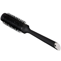 Thumbnail for Black hairbrush with a silver logo on a white background