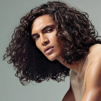 Thumbnail for Person with curly hair against a plain background