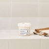 Thumbnail for Jar of NOUNOU product on a bathroom shelf with a towel in the background