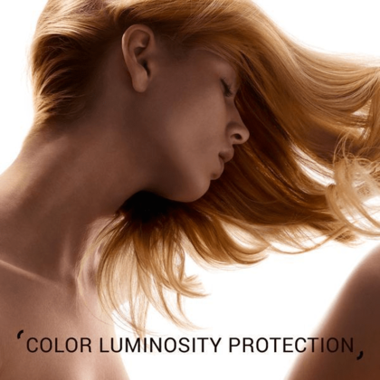 Woman with flowing hair and text 'Luminous Protection Cream' on a light background