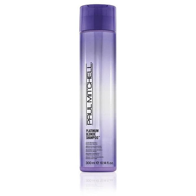 A bottle of Paul Mitchell Platinum Blonde Shampoo with purple and white labeling, indicating it is designed for blonde, grey, or white hair.